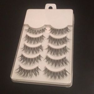 5 pairs of lashes with a sample of lipstick